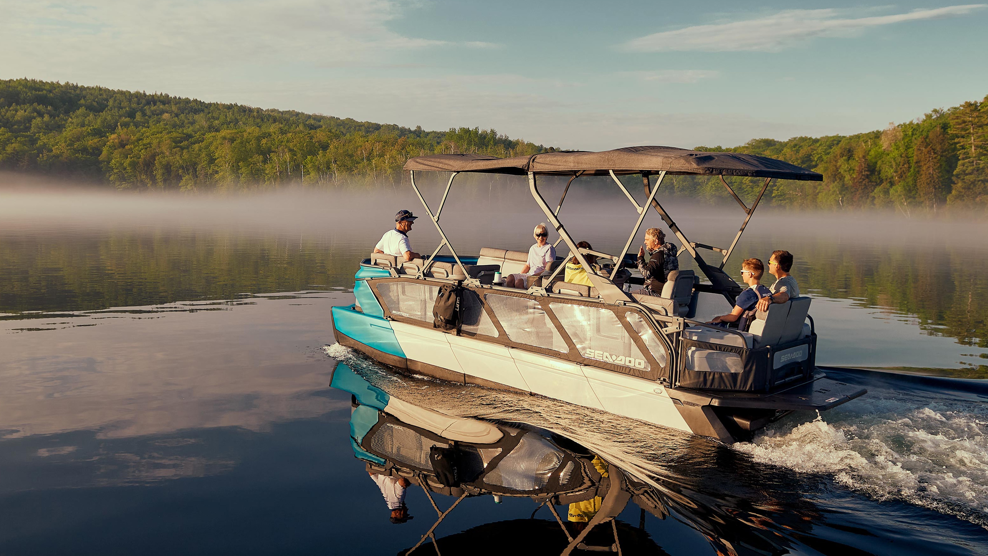 Family enjoying a good moment on their Sea-Doo SWITCH pontoon boat