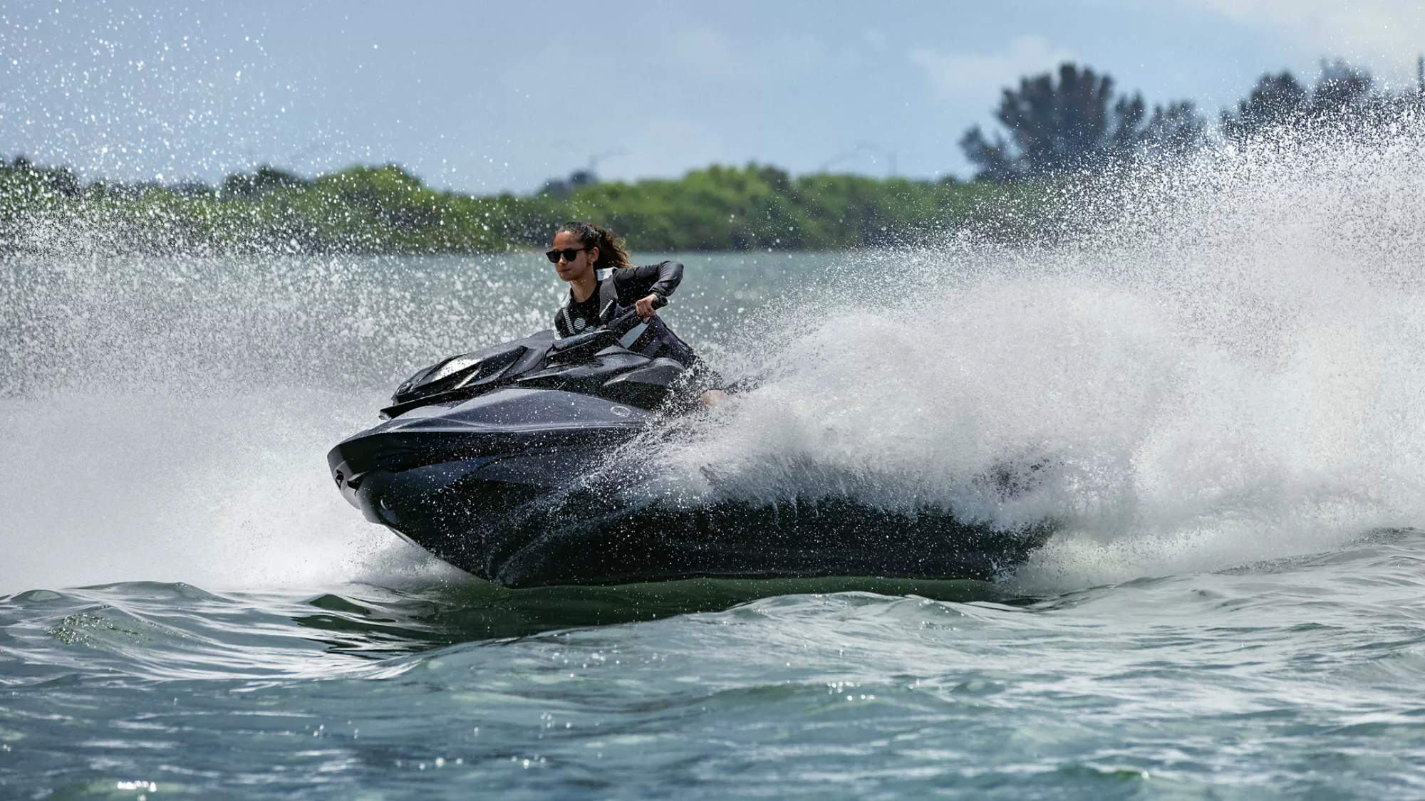 Women riding a Sea-Doo RXT-X personal watercraft