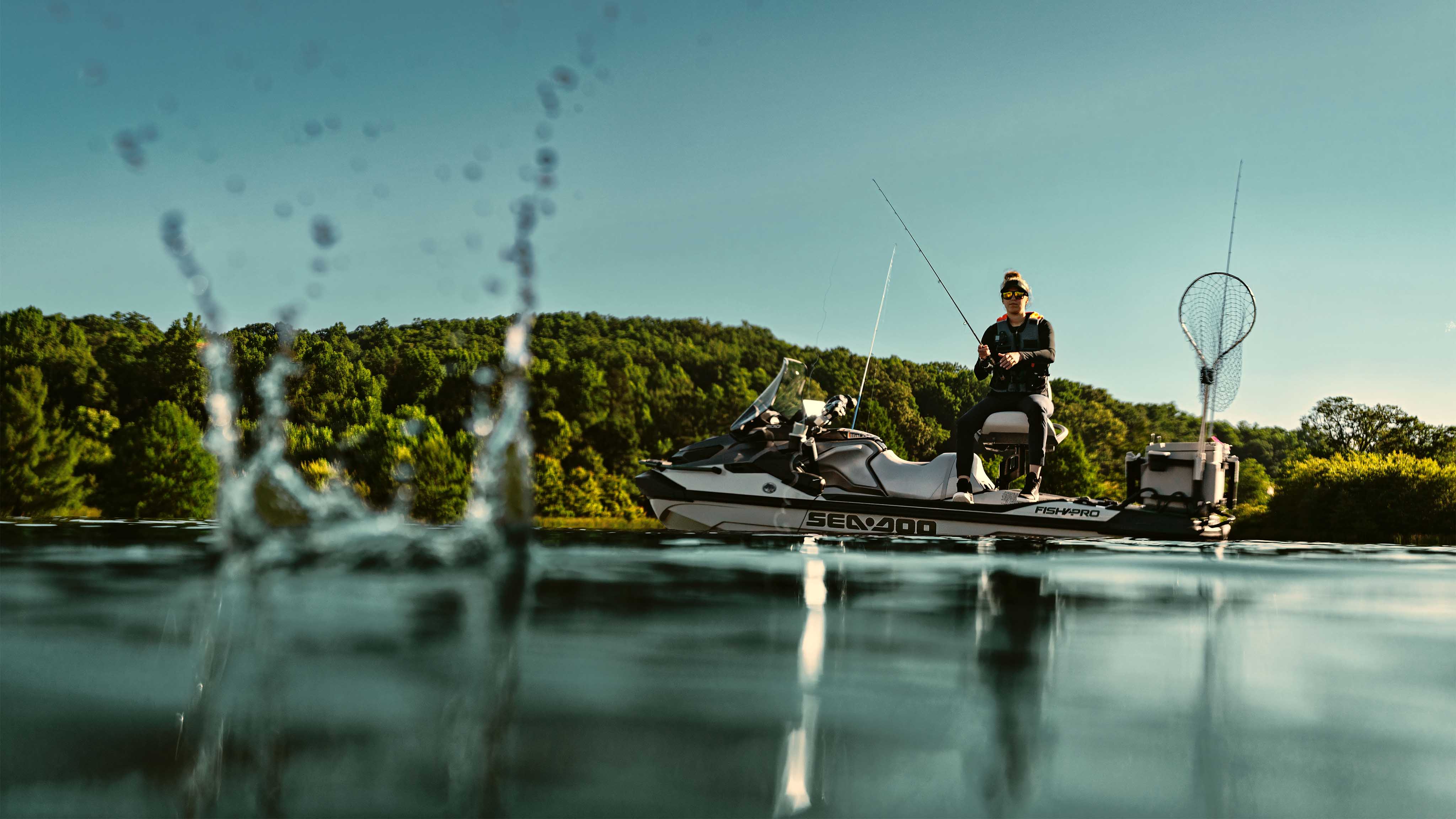 A woman fishing from a 2025 Sea-Doo FishPro Apex personal watercraft.