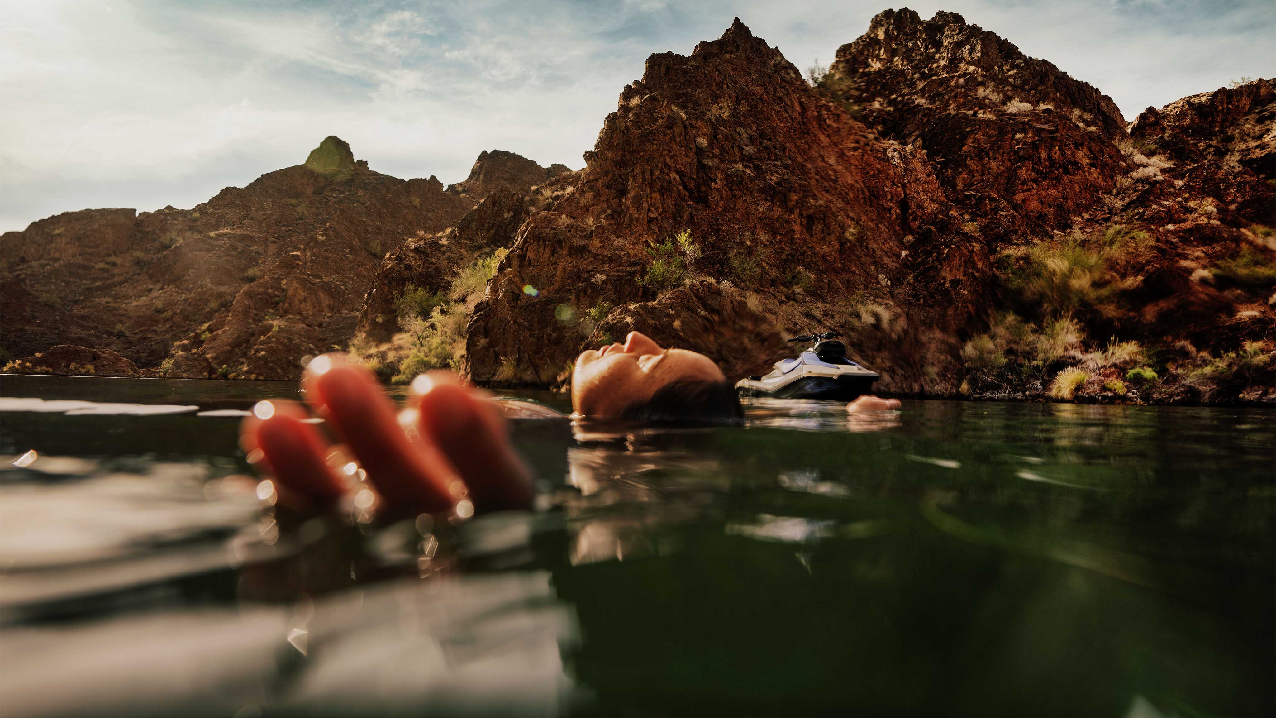 Woman in water near a 2025 Sea-Doo personal watercraft