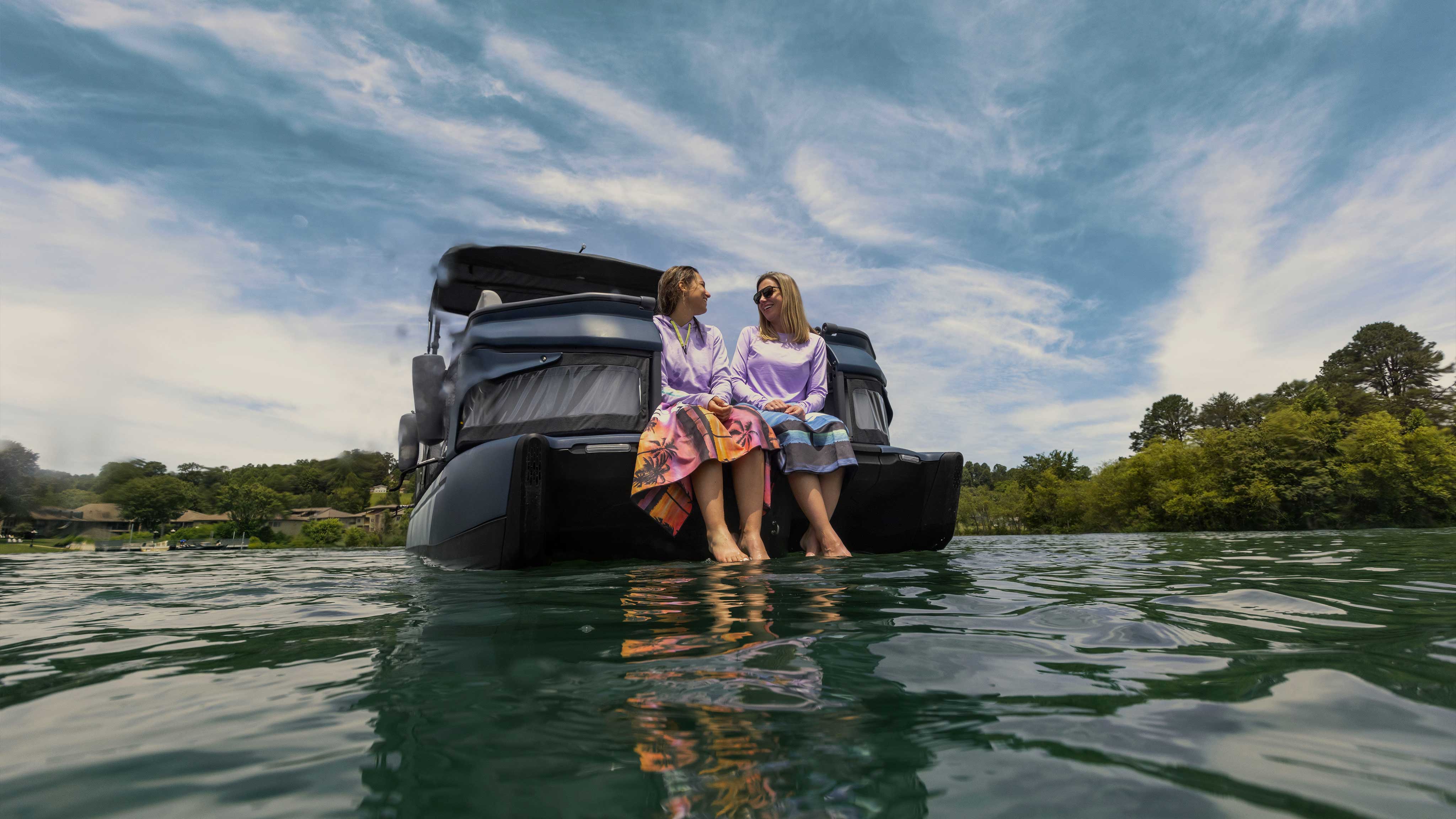 Two women sitting on the 2025 Sea-Doo Switch Cruise Limited pontoon boat