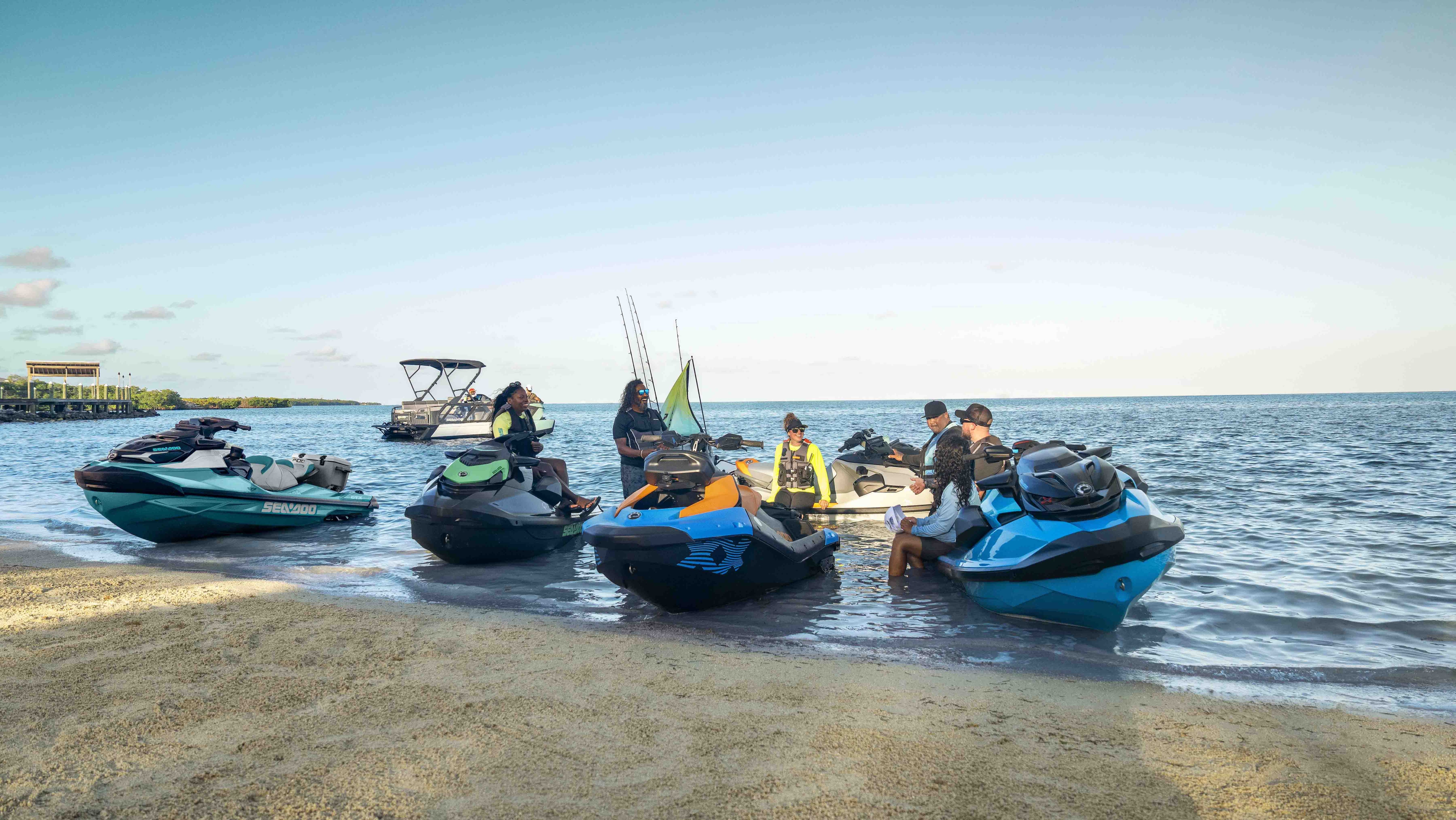 Many Sea-Doo personal watercrafts and pontoons 2026 docked on the beach