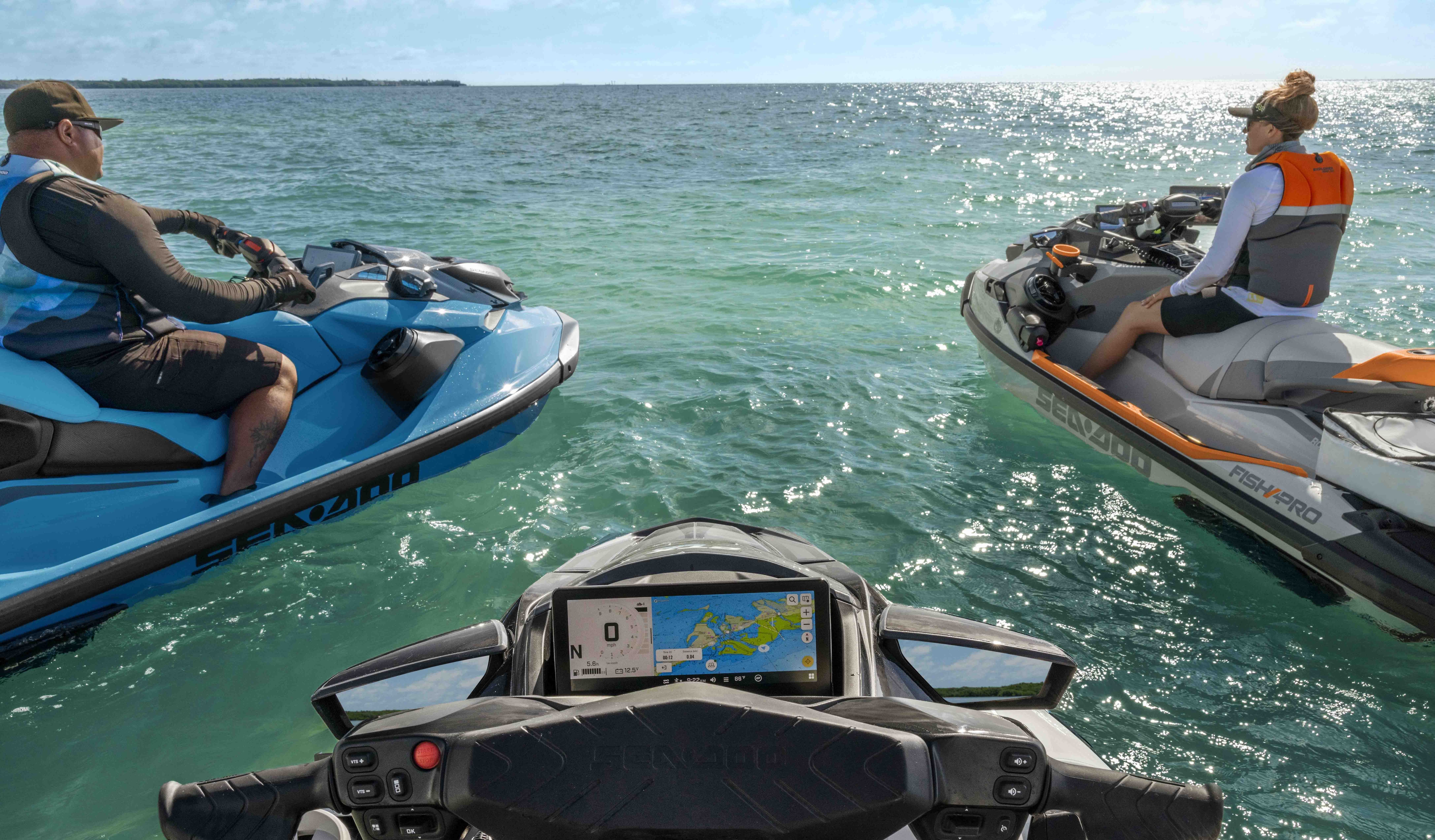 Several Sea-Doo personal watercraft up for a beautiful summer day on clear water