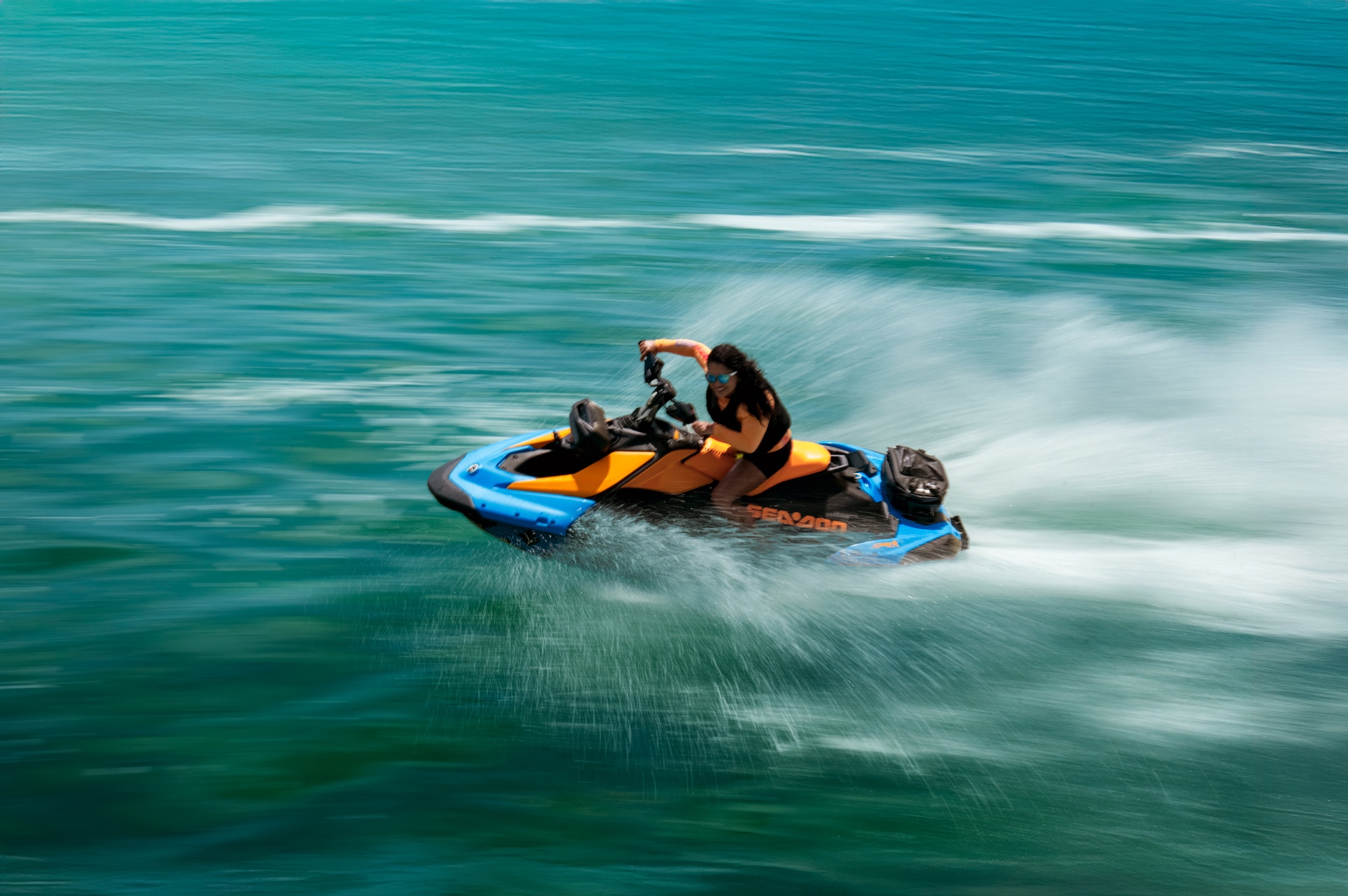 A woman speeding through the water on her 2026 Sea-Doo Spark watercraft