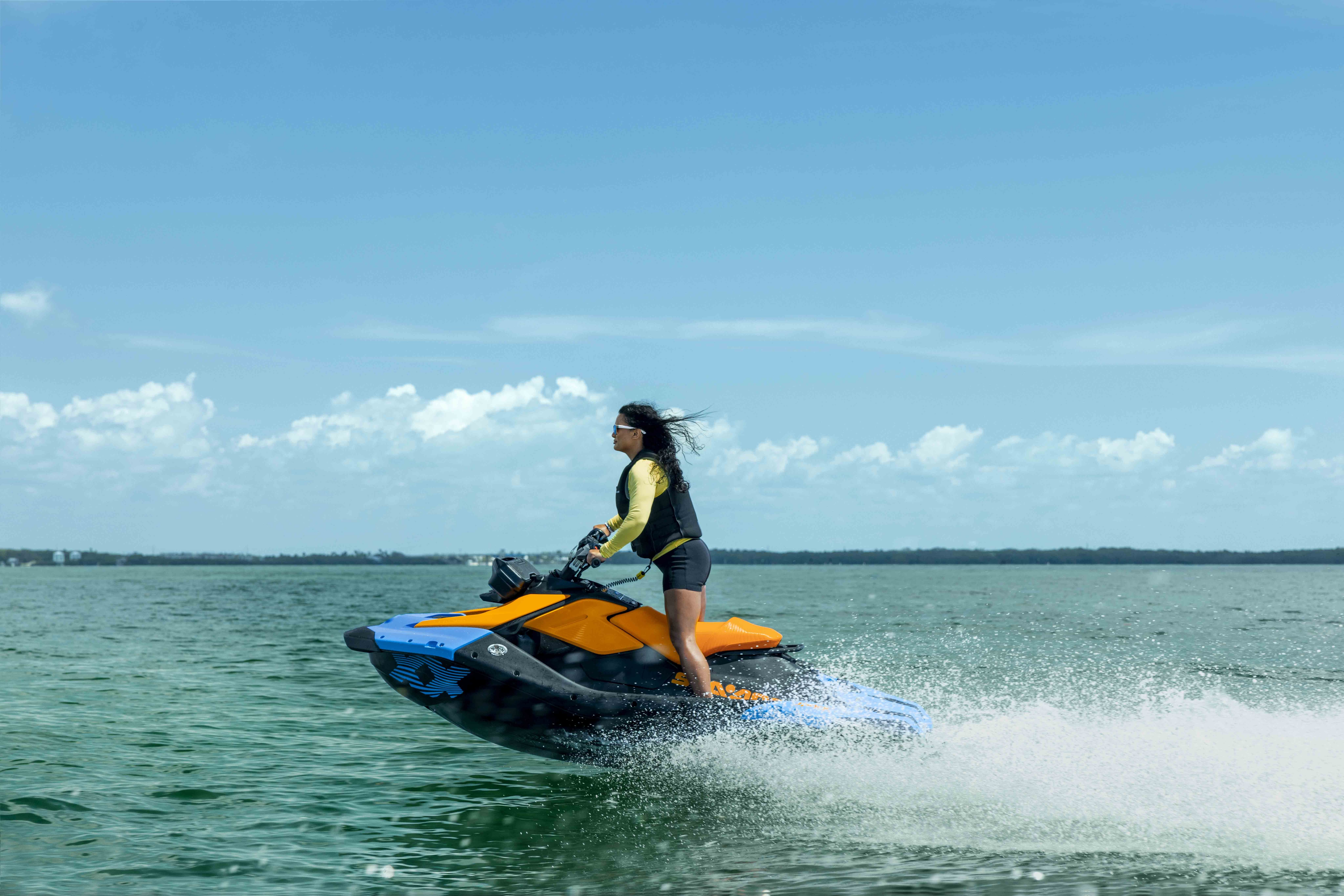 Couple riding a Sea-Doo Spark Trixx personal watercraft