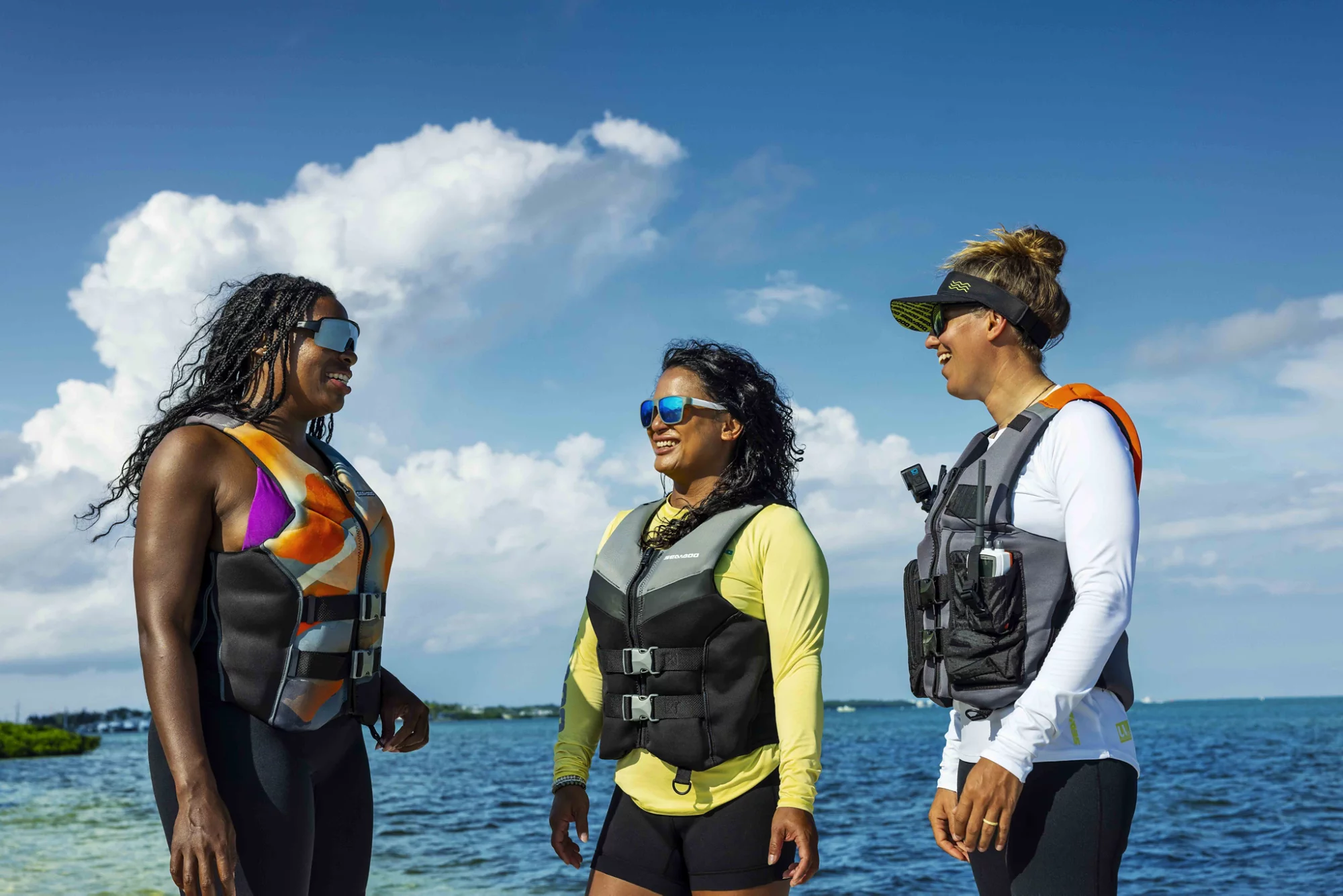 A woman zipping up her Sea-Doo PFD