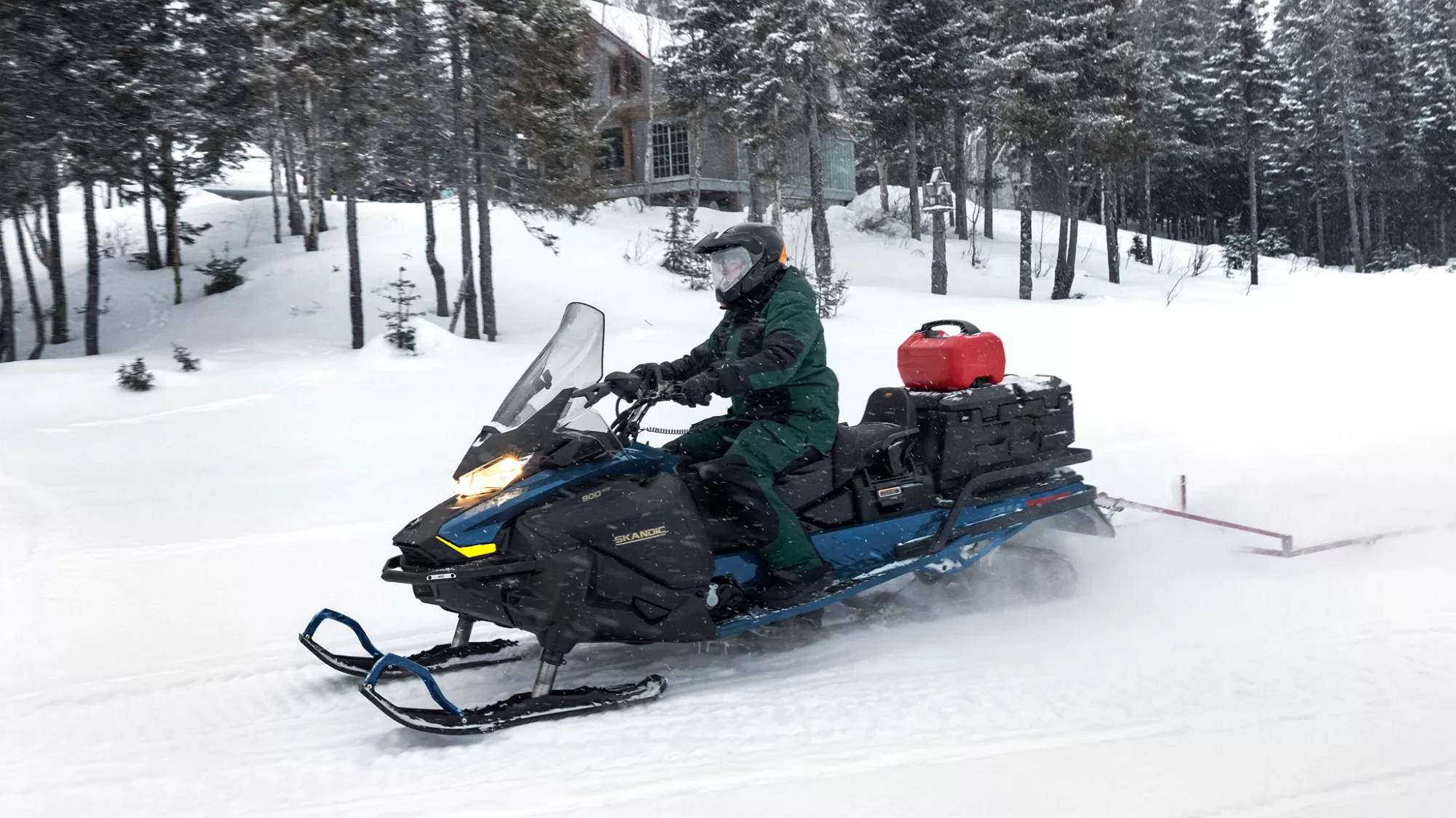 Ski-Doo Skandic SE utility snowmobile riding on a snowy trail