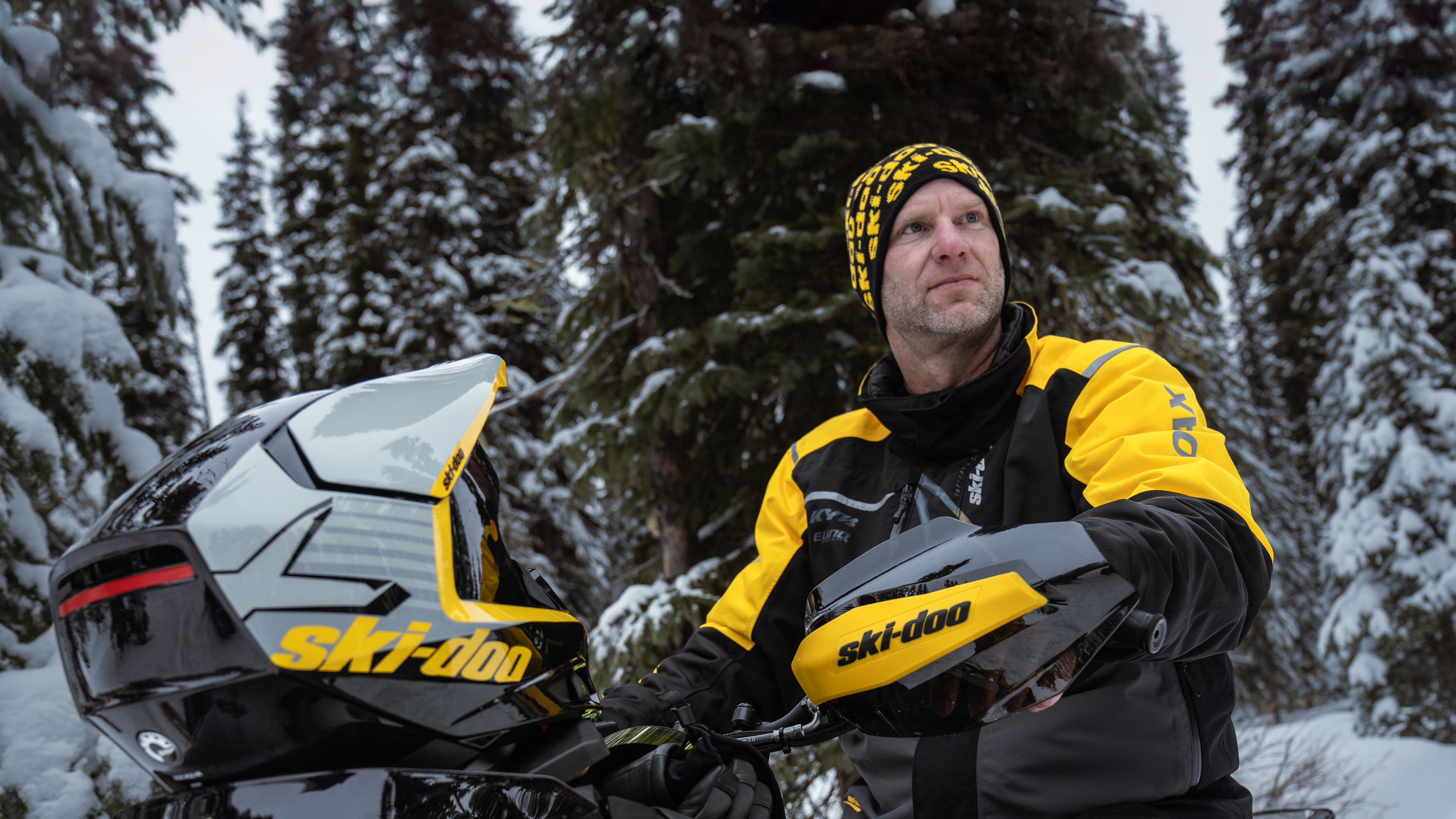 Rider wearing Ski-Doo branded snowmobiling gear