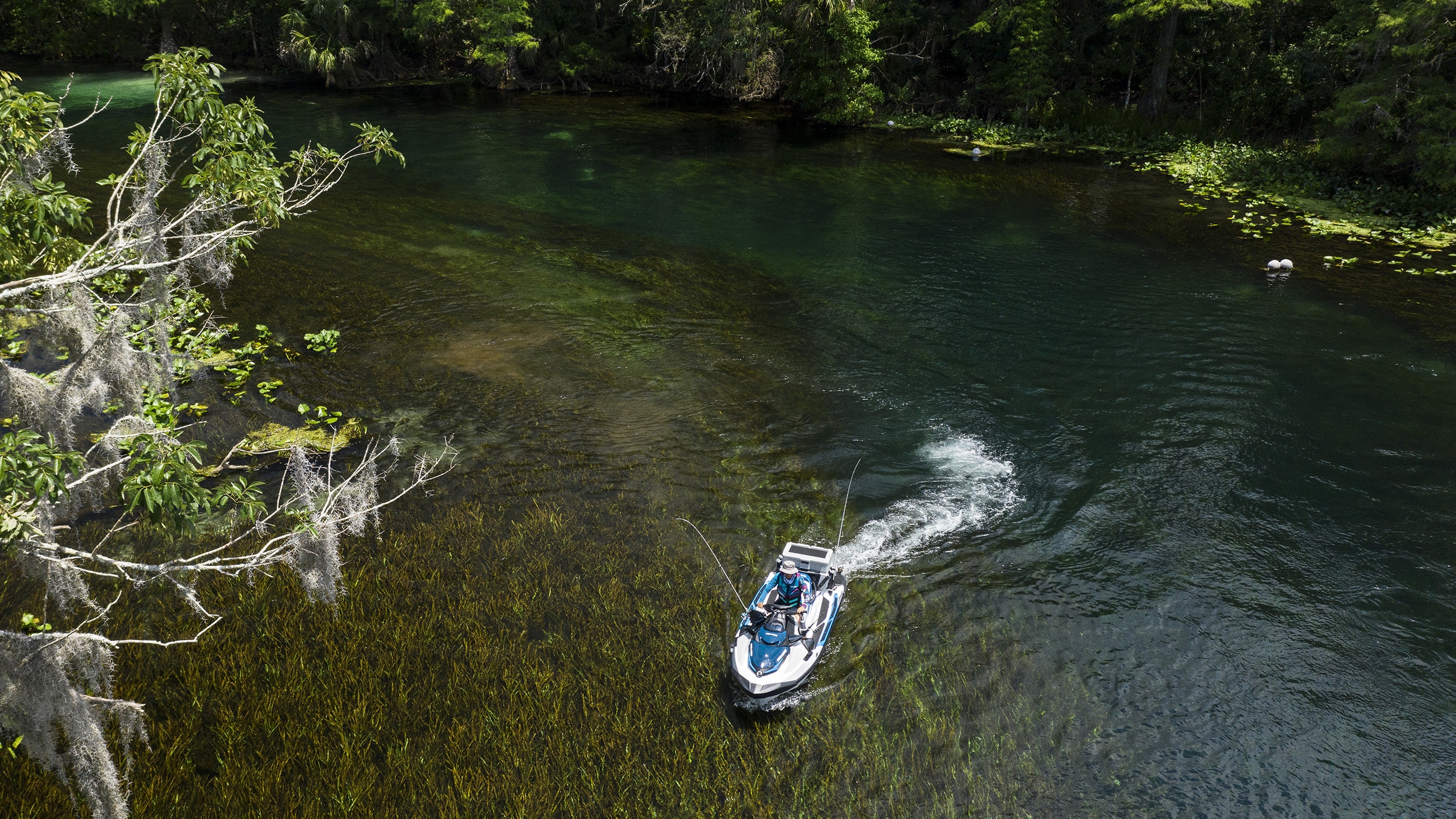Woman riding a Sea-Doo FISHPRO in a river